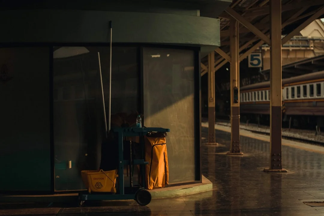 A modern kitchen undergoing renovation, featuring a worker, tools, and materials.